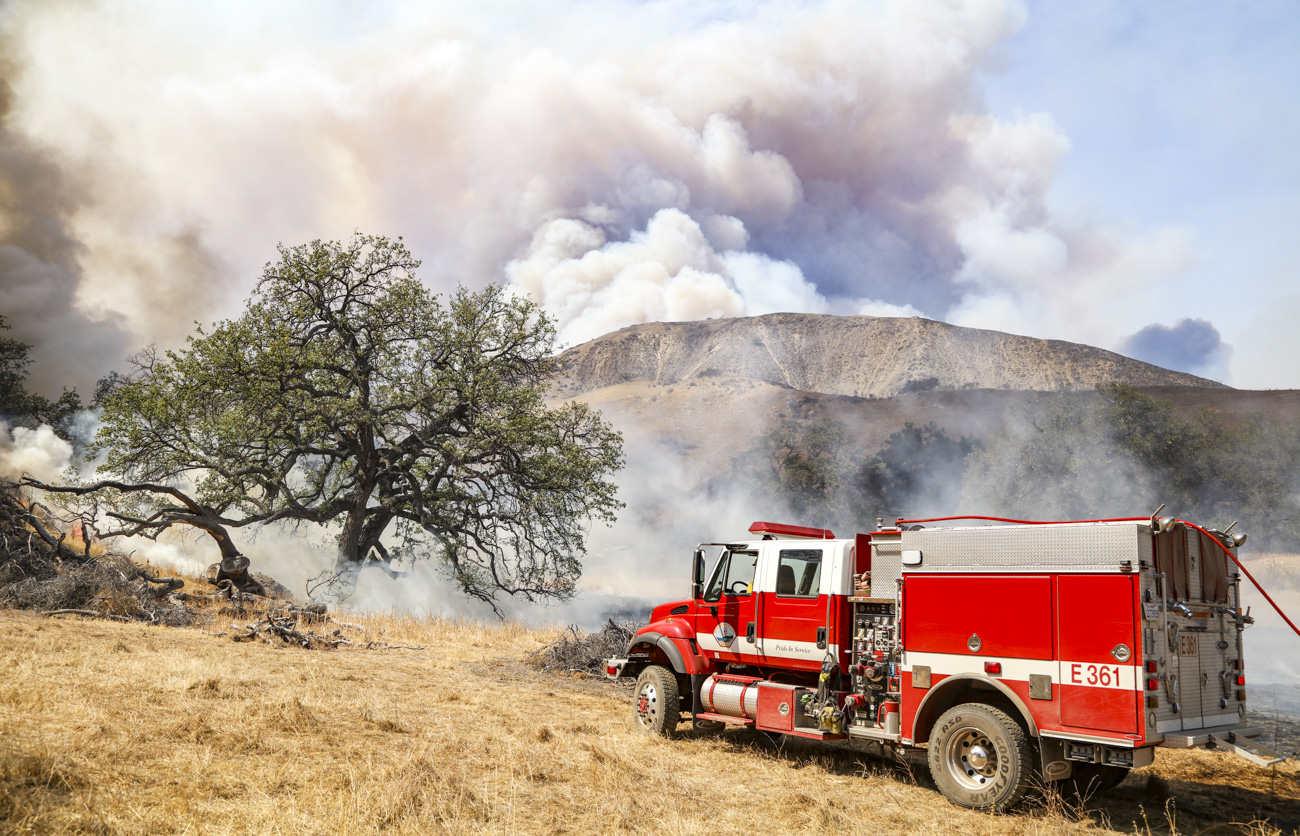 Engine 361 holds position as smoke columns rise over the Rey Fire ridgeline, 2017.